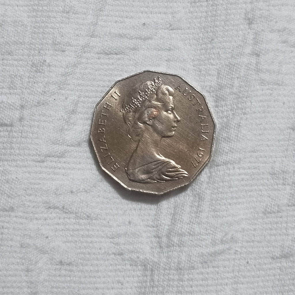 1977 Silver Jubilee 50 cent coin with heavy toning
