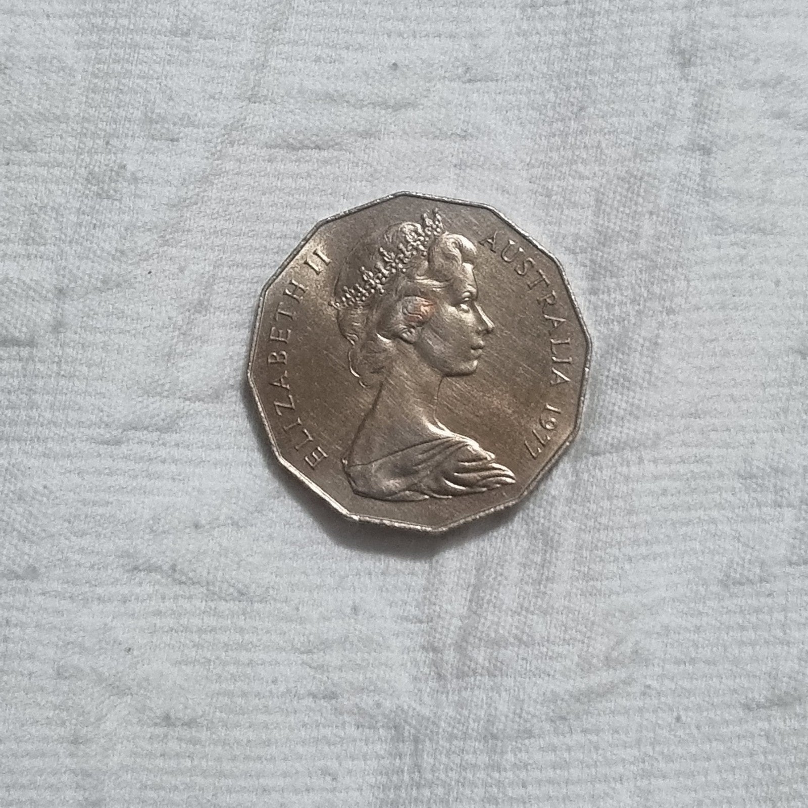 1977 Silver Jubilee 50 cent coin with heavy toning